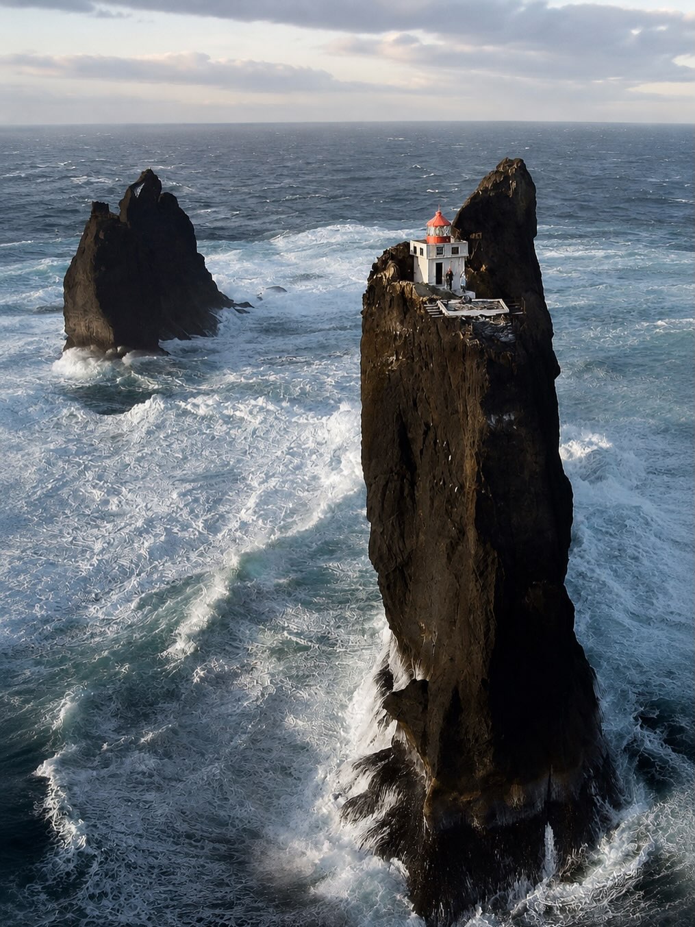 Icelandic Lighthouse Stands Alone On Remote Sea Stack
