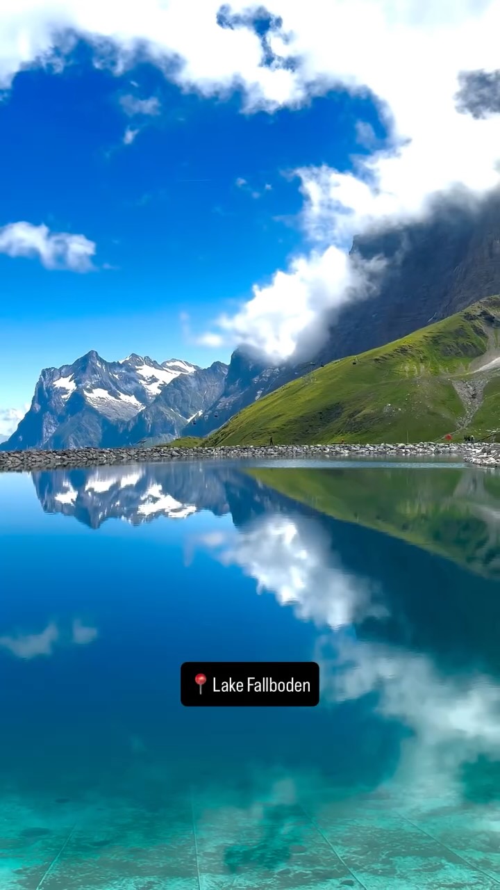 Swiss Alps' Majestic Peaks and Reflecting Lake