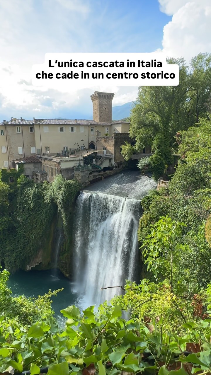 Italian Town With Waterfall Cascading Into Historic Center