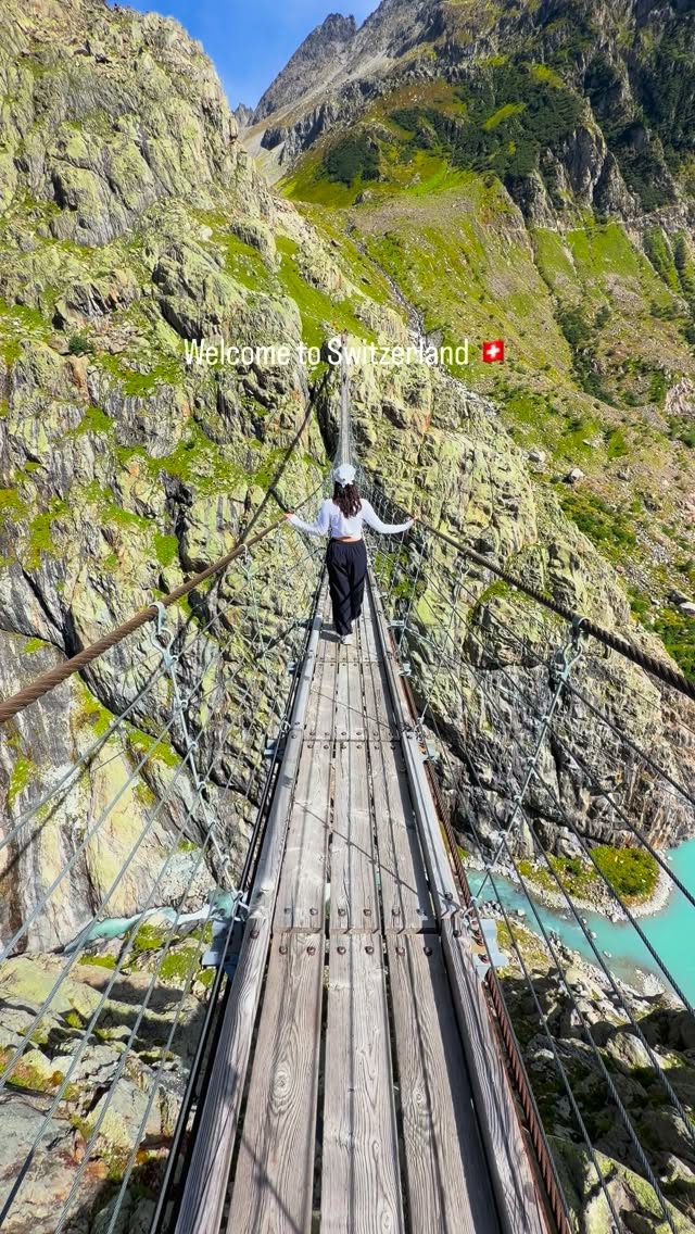 Suspension Bridge Over Turquoise Swiss Alps Lake