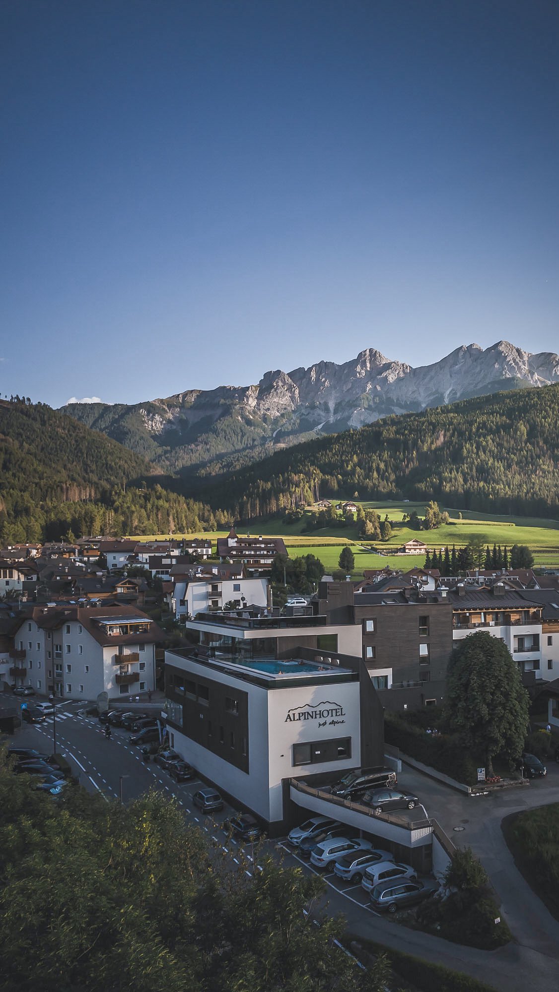 Dolomites Scenery: Lake, Church, and Hotel