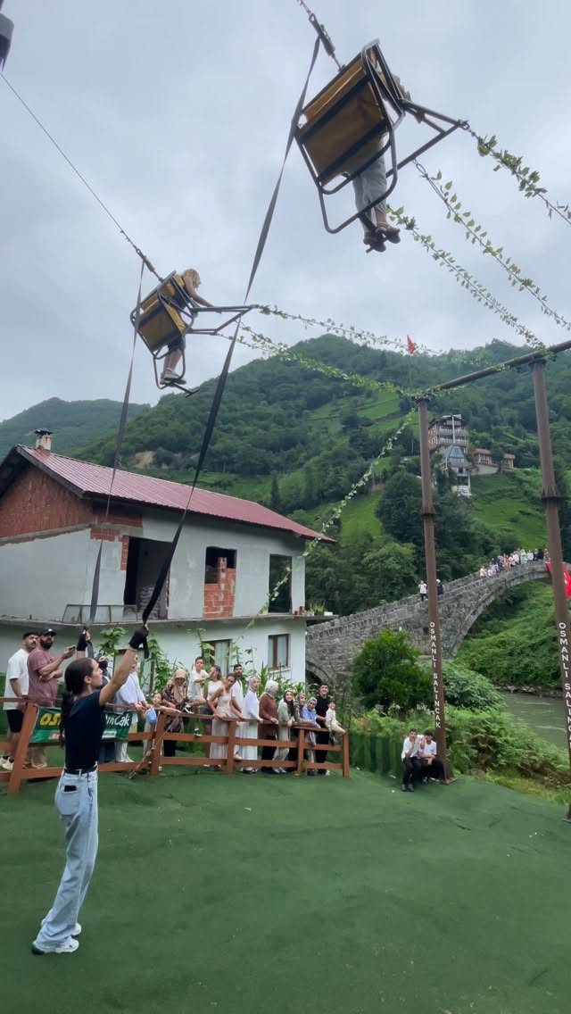 Scenic Swing Over River Near Ancient Bridge