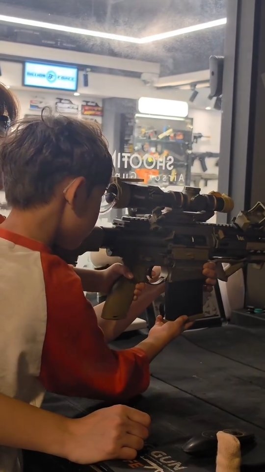 Father and Son Experience Simulated Shooting Range