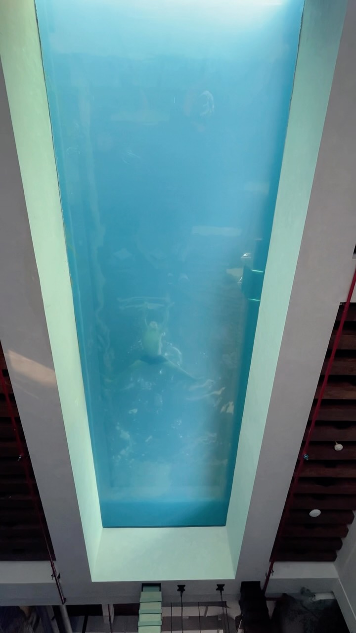 Hotel Room with Transparent Pool and City Views