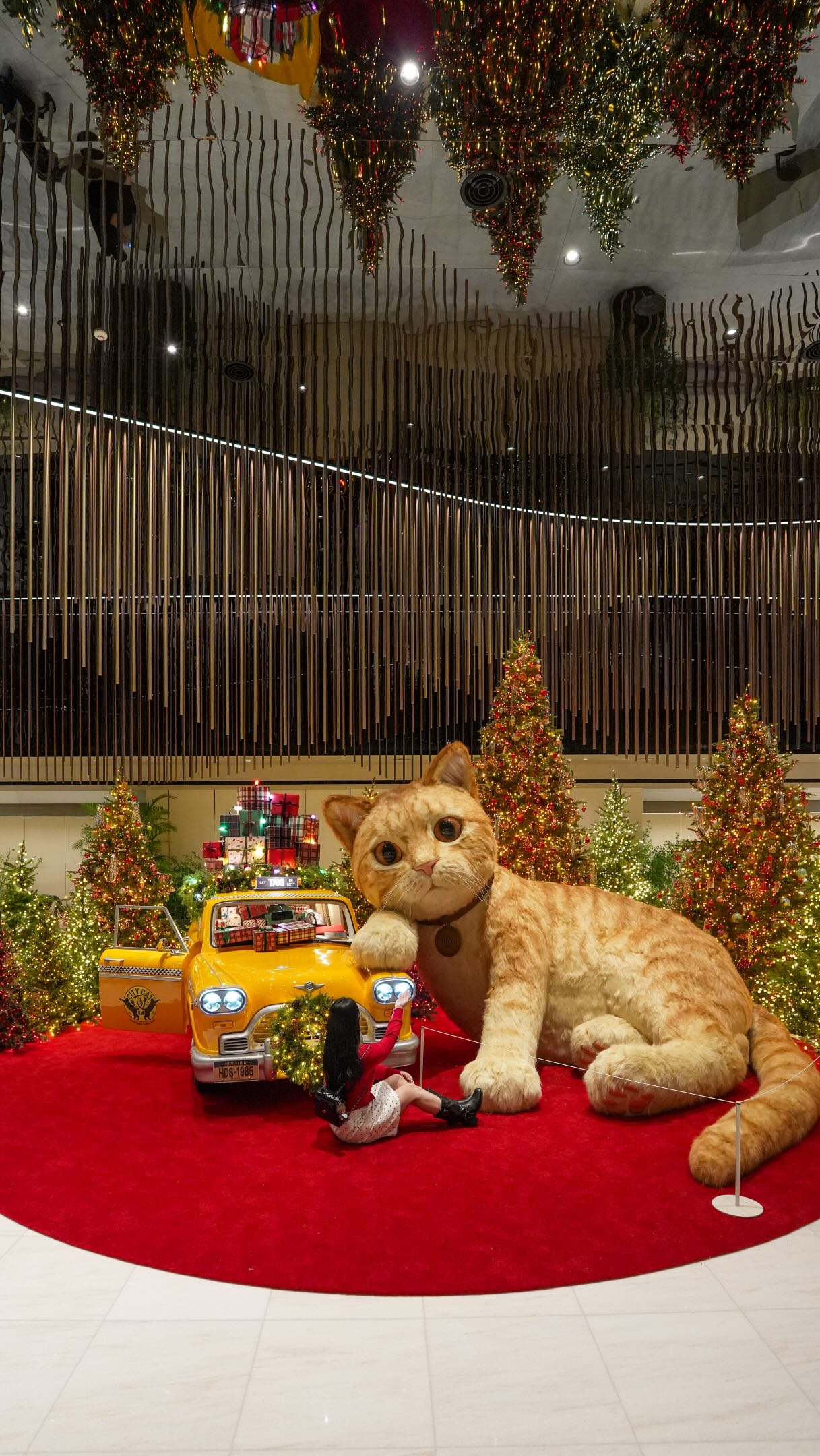 Giant Cat Sculpture Amidst Christmas Trees