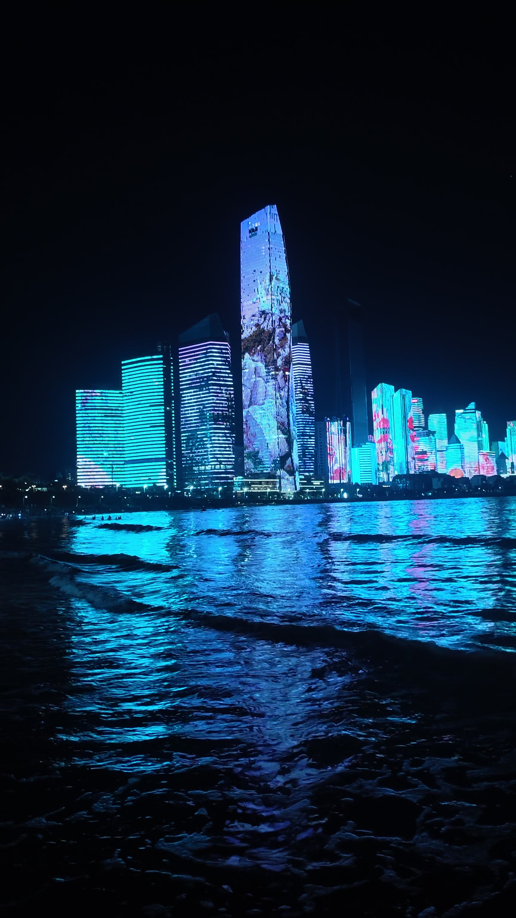 Bioluminescent Beach Meets Cyberpunk Cityscape